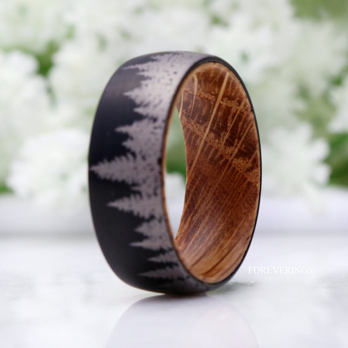 Black tungsten forest band turned to show the whiskey barrel wood grain inside