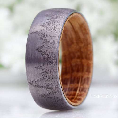 Men's 8mm silver tungsten band with a forest tree-line engraving and whiskey barrel wood lining
