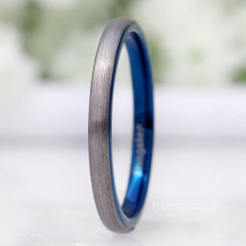 2mm two-tone tungsten band with a brushed silver outside and blue inside, standing on edge