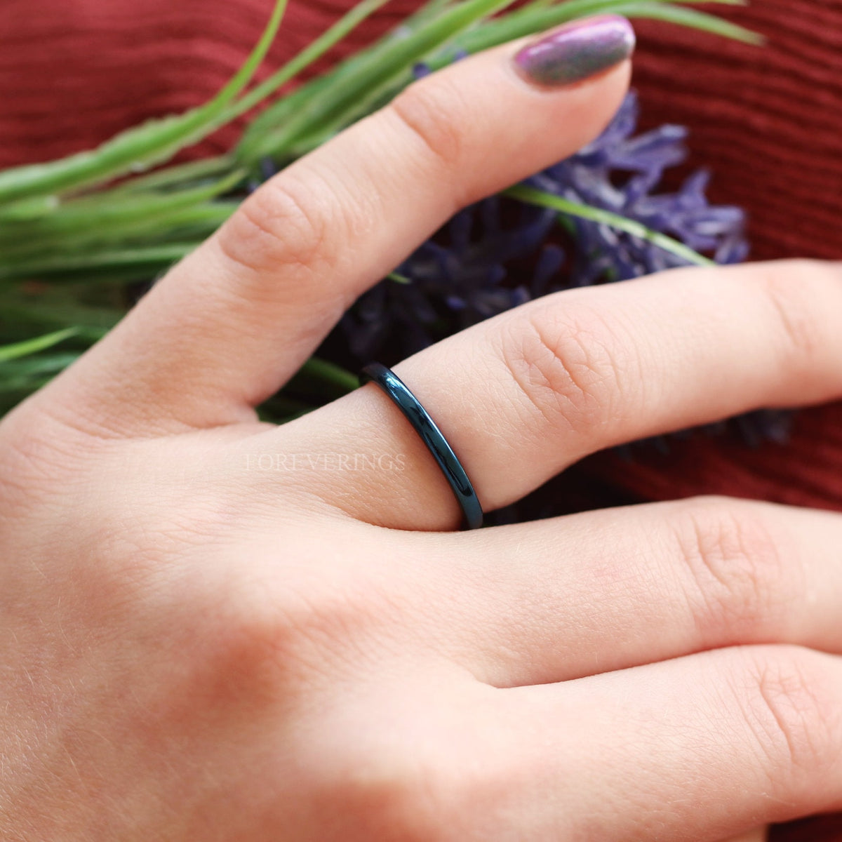 2mm blue tungsten band worn on a hand