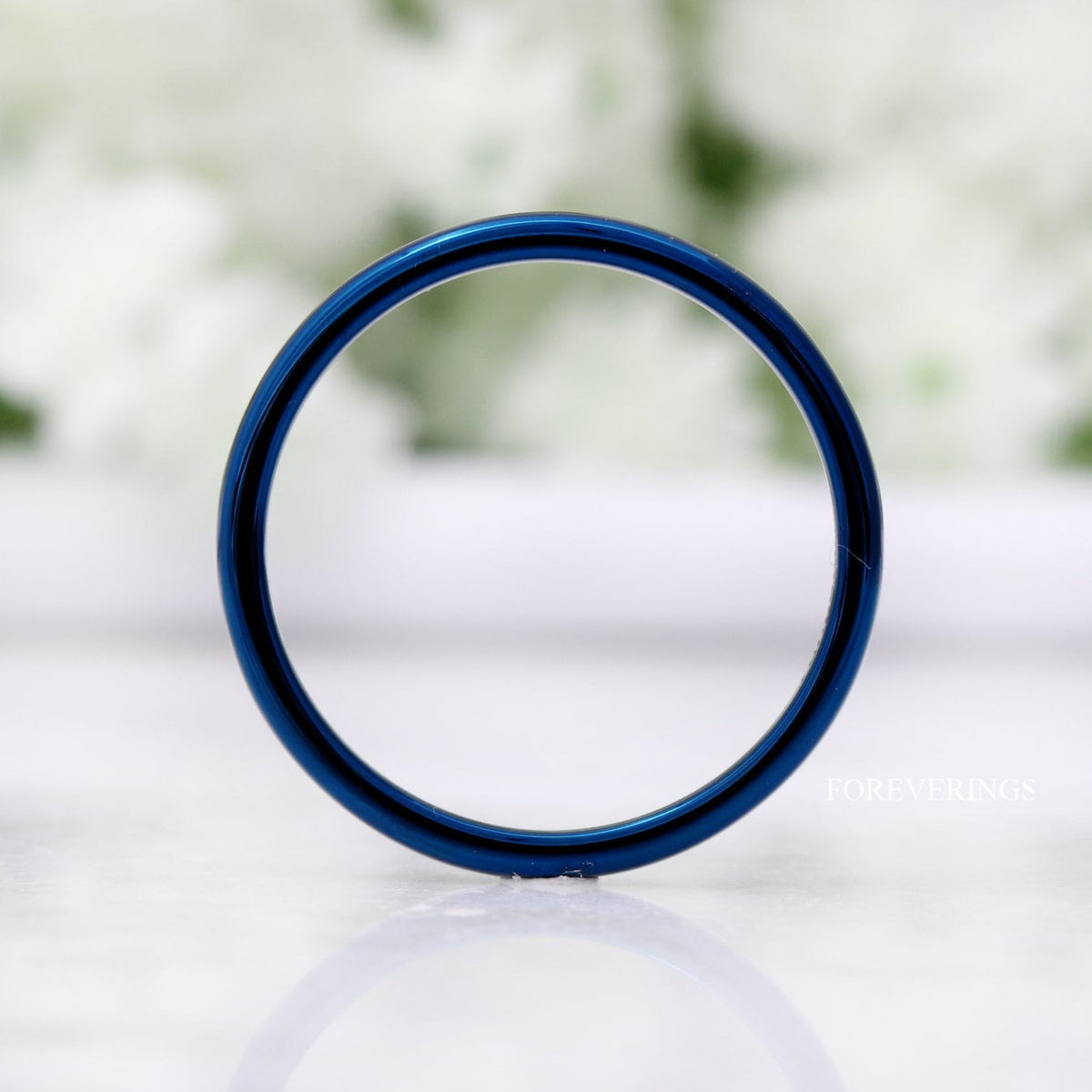 2mm blue tungsten band standing upright, viewed straight through the center