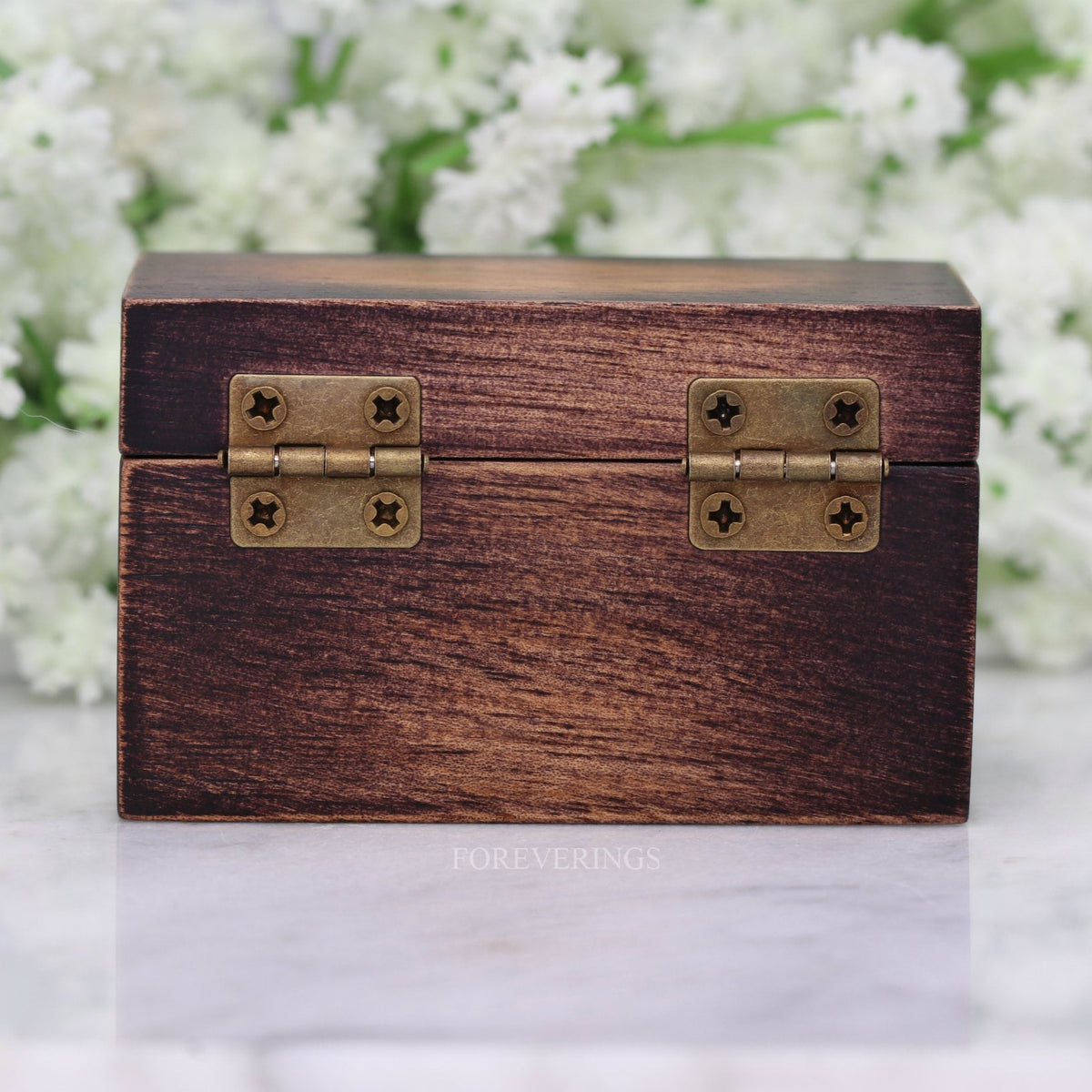 Back of the wood ring box showing its two brass hinges