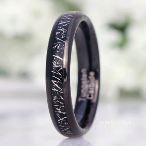4mm black tungsten wedding band with a meteorite-look inlay, standing at an angle