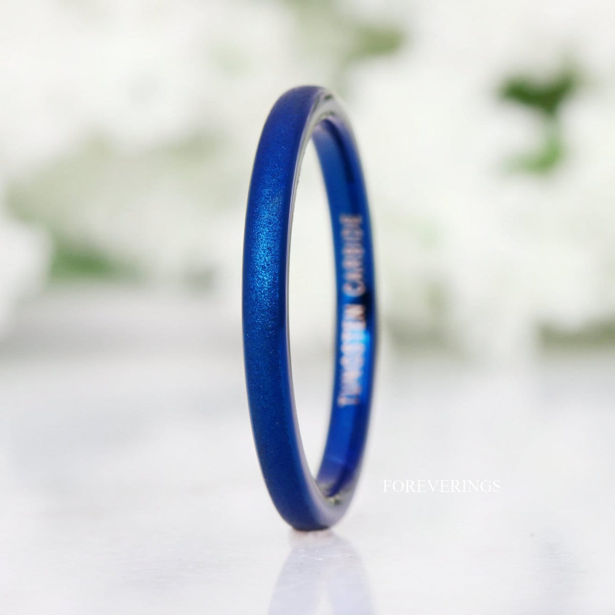Thin 2mm blue tungsten band angled to show the polished blue interior