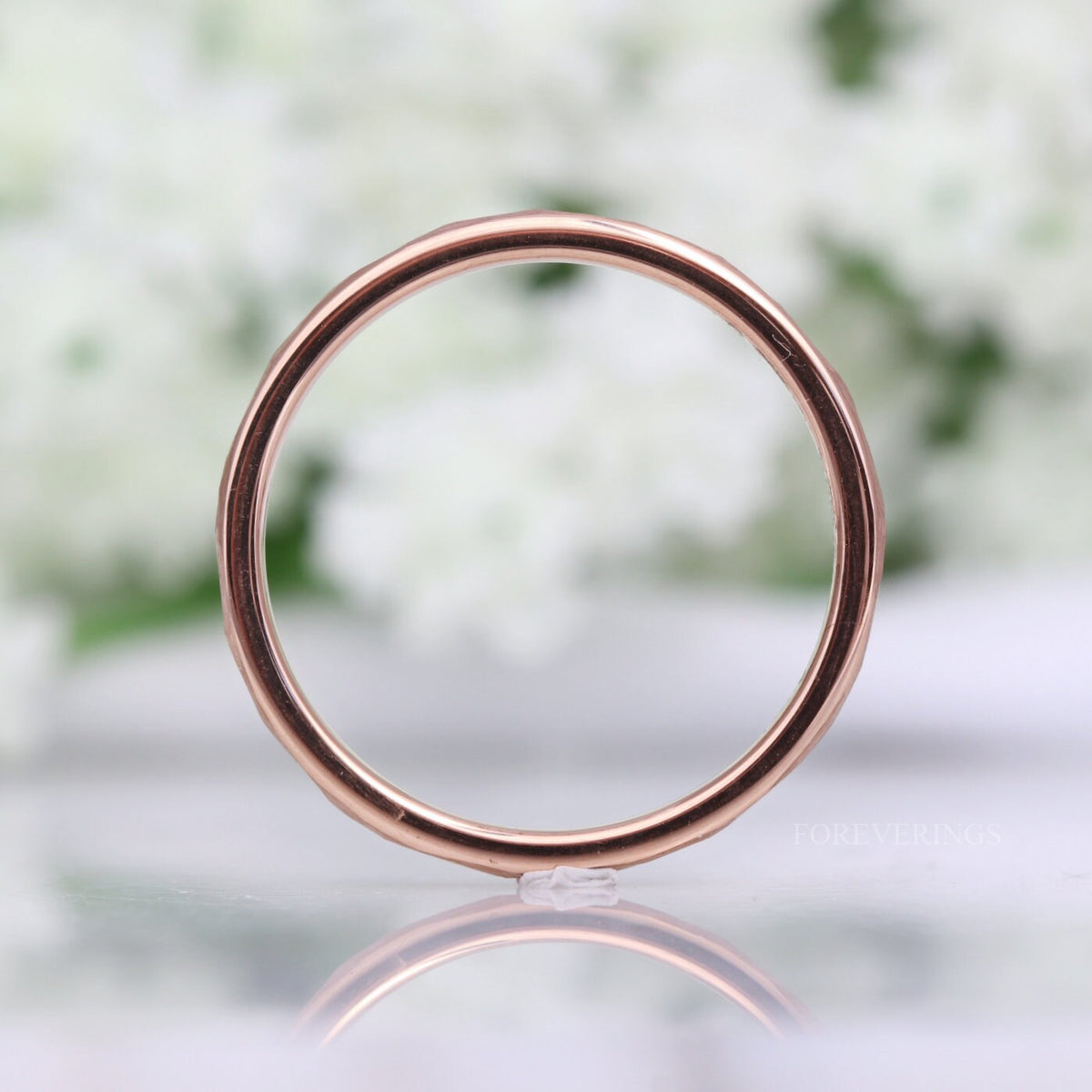 Hammered rose gold tungsten ring seen straight on through the center