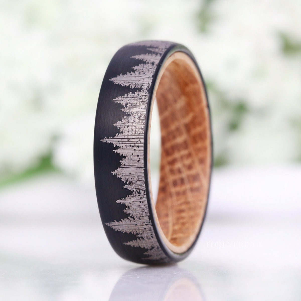 Men's 6mm black tungsten forest band with whiskey barrel wood lining, standing upright