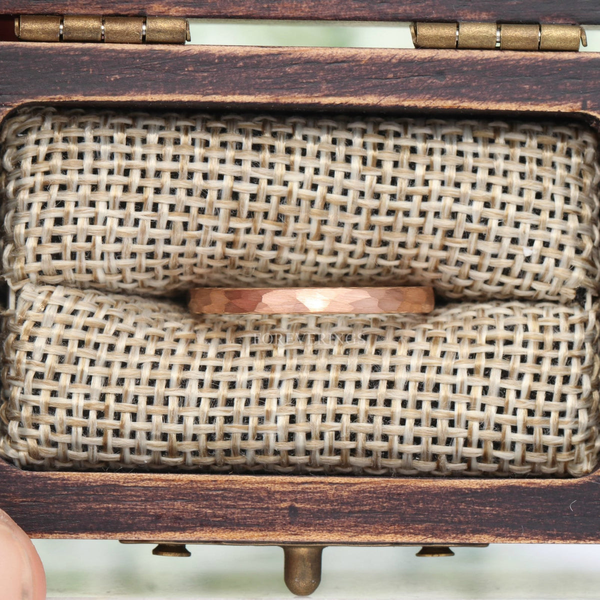 2mm hammered rose gold tungsten ring in a rustic wood ring box with burlap insert