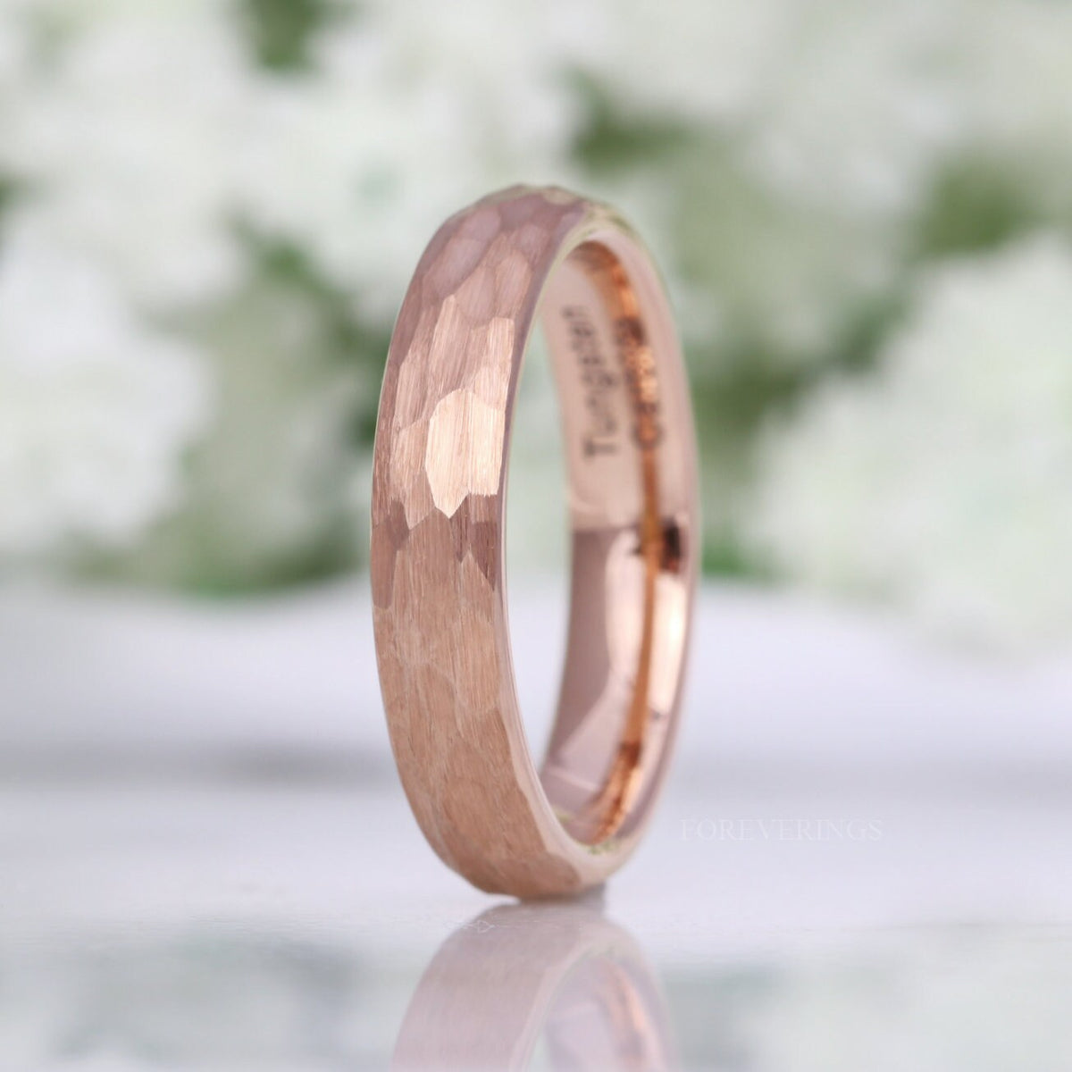 4mm hammered rose gold tungsten band standing upright, interior visible