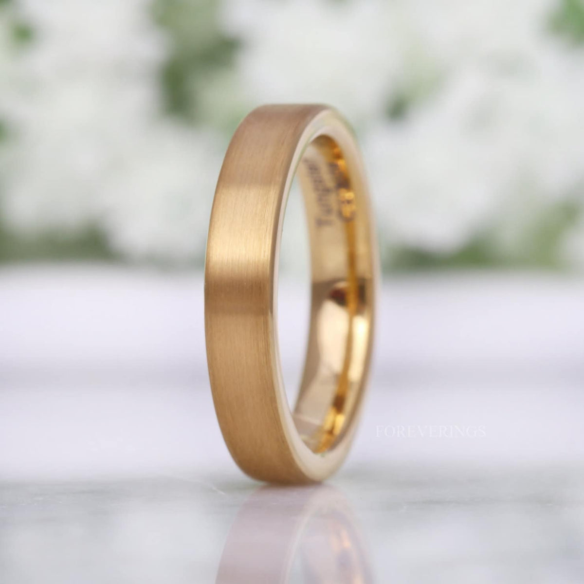 4mm matte gold tungsten flat band standing upright, angled