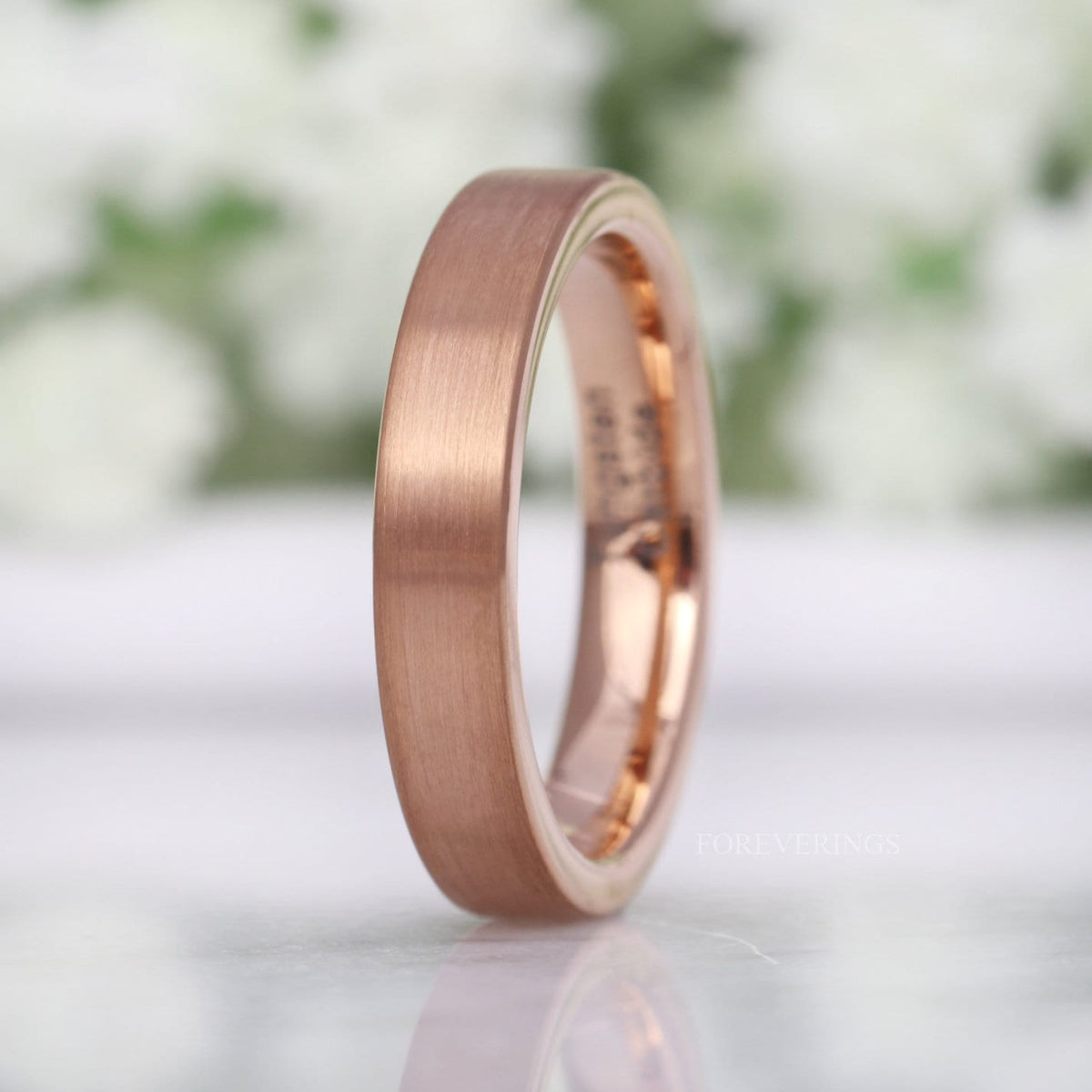 4mm matte rose gold tungsten band standing at an angle to show the polished interior
