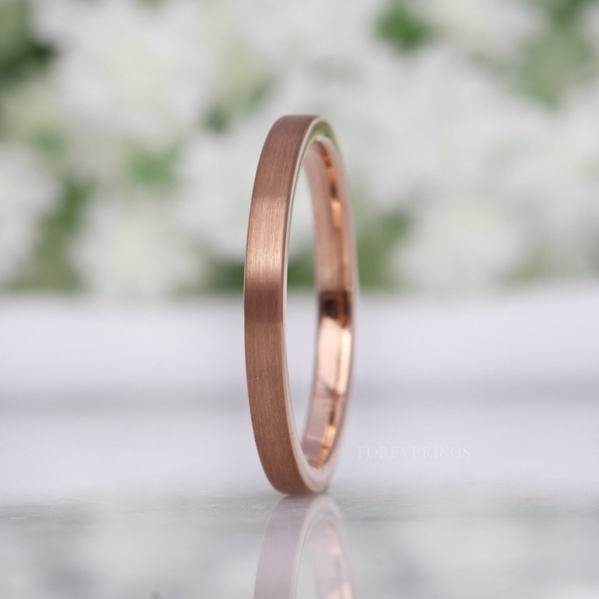 2mm matte rose gold tungsten band standing on edge, side view of the flat profile