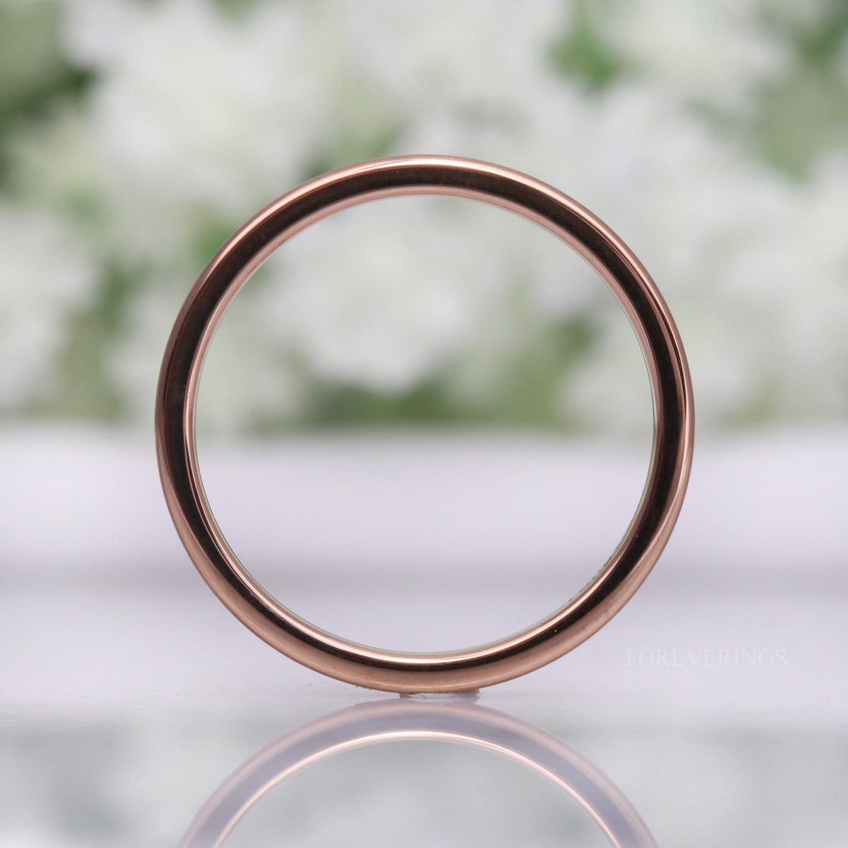 2mm matte rose gold tungsten band standing upright, seen straight on as a thin circle