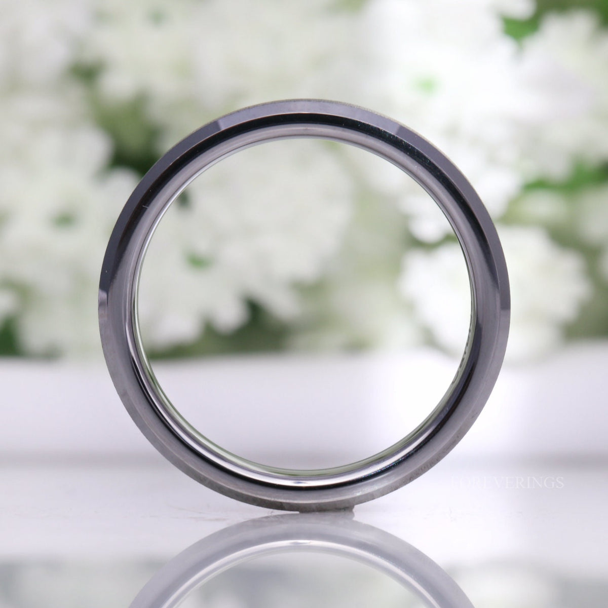 4mm silver tungsten ring standing upright, viewed straight through the center