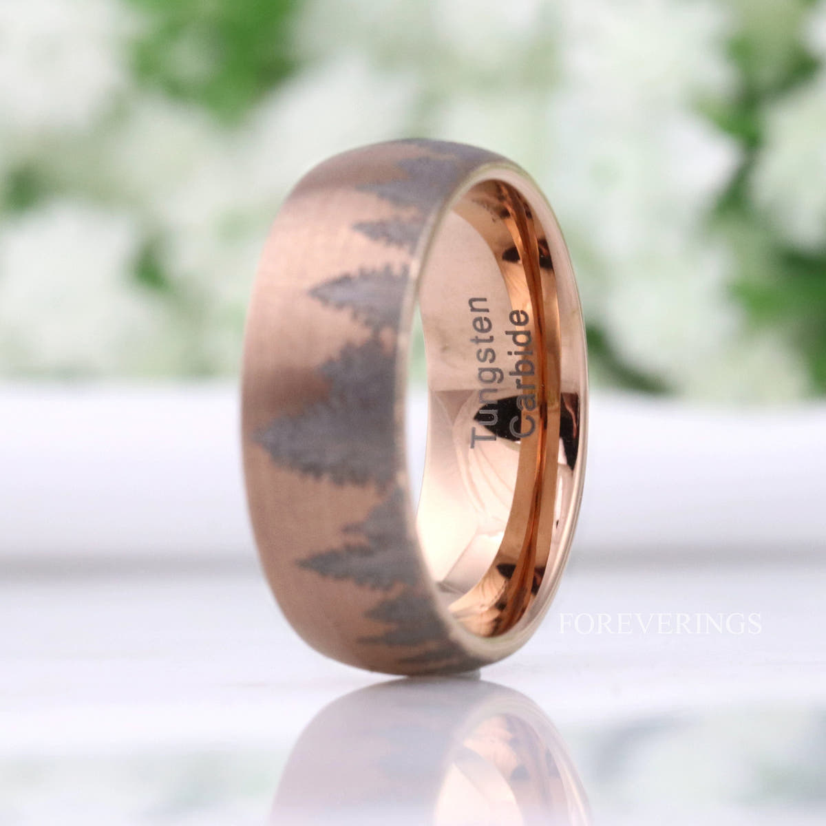 Rose gold tungsten forest band angled to show the polished rose gold interior