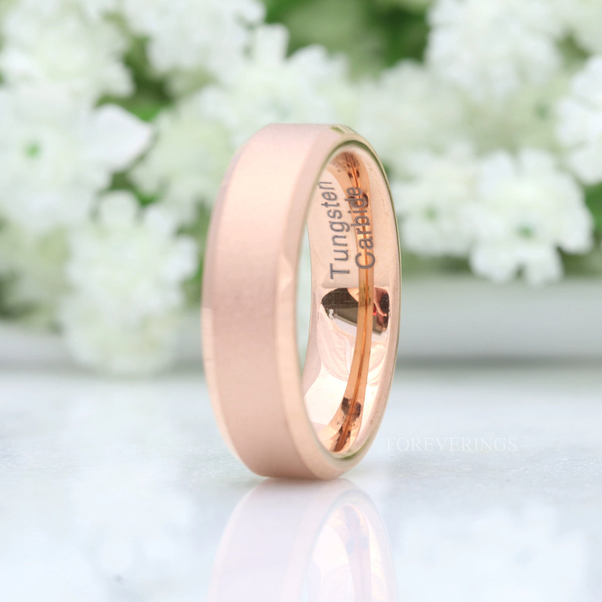 Flat rose gold tungsten wedding band with matte sandblasted finish, second standing view