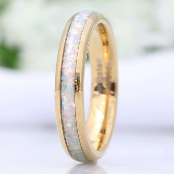 Women's 4mm gold tungsten wedding band with crushed white fire opal inlay, close crop