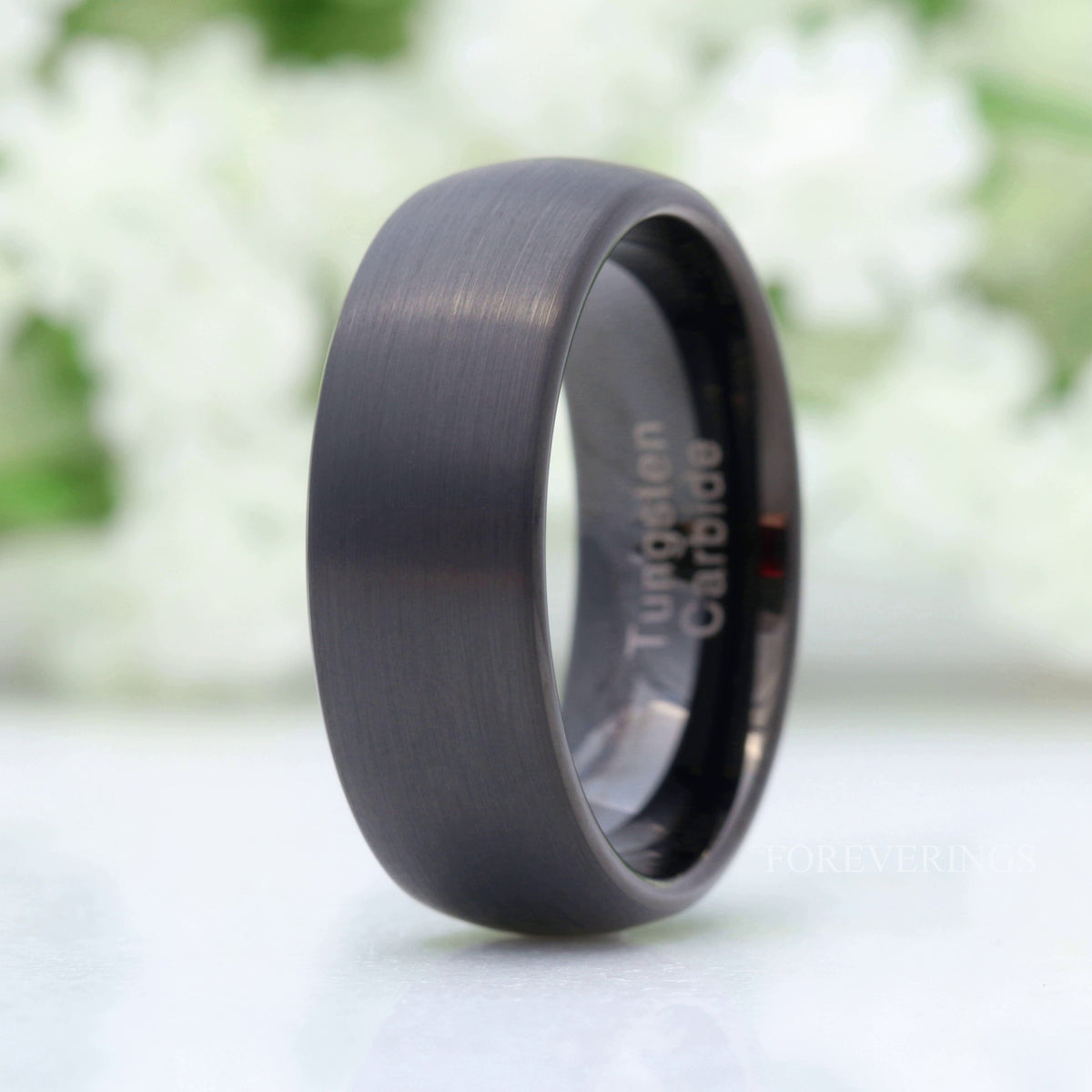 8mm brushed black tungsten band with a domed profile, standing at an angle