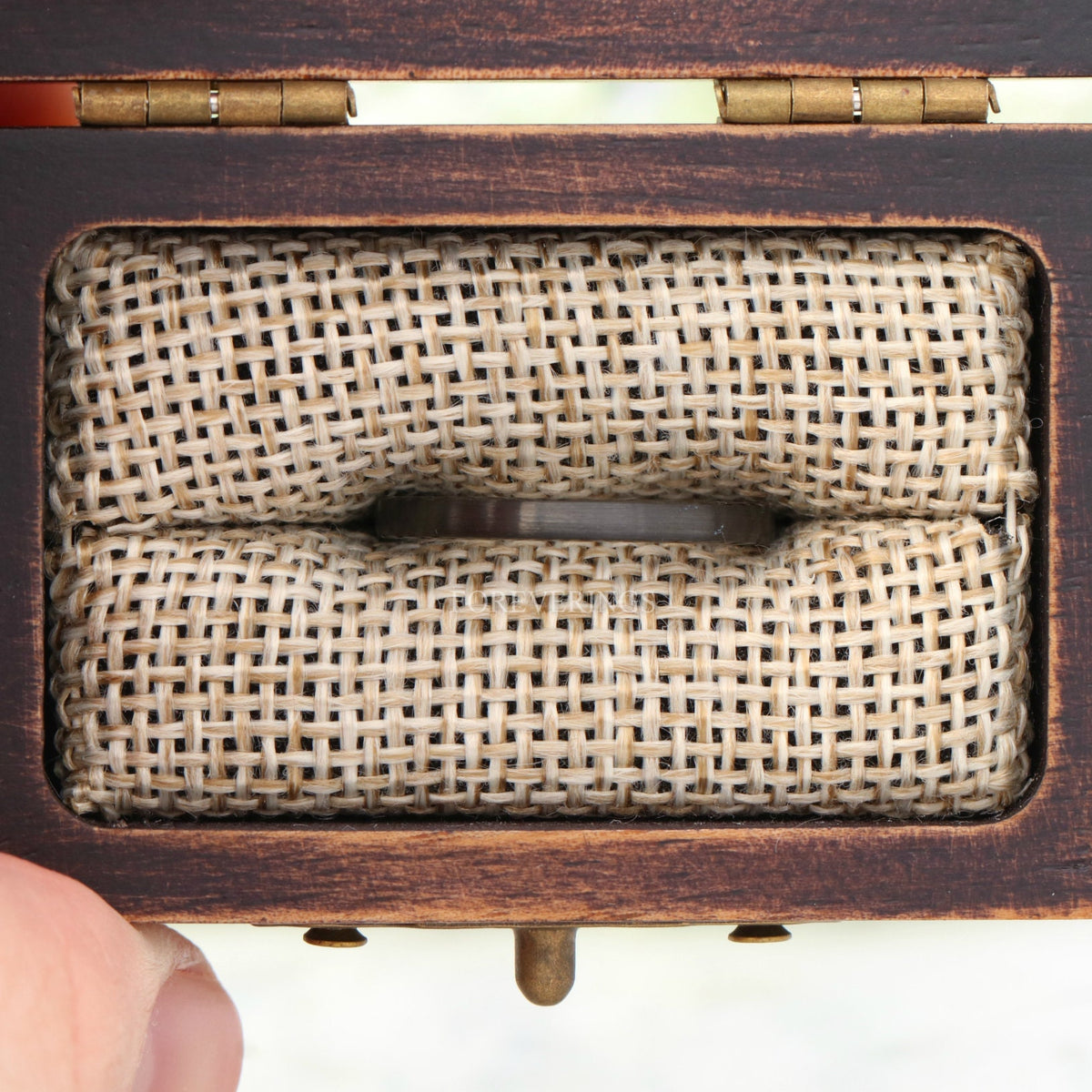 Black tungsten band in a rustic wood ring box with burlap insert