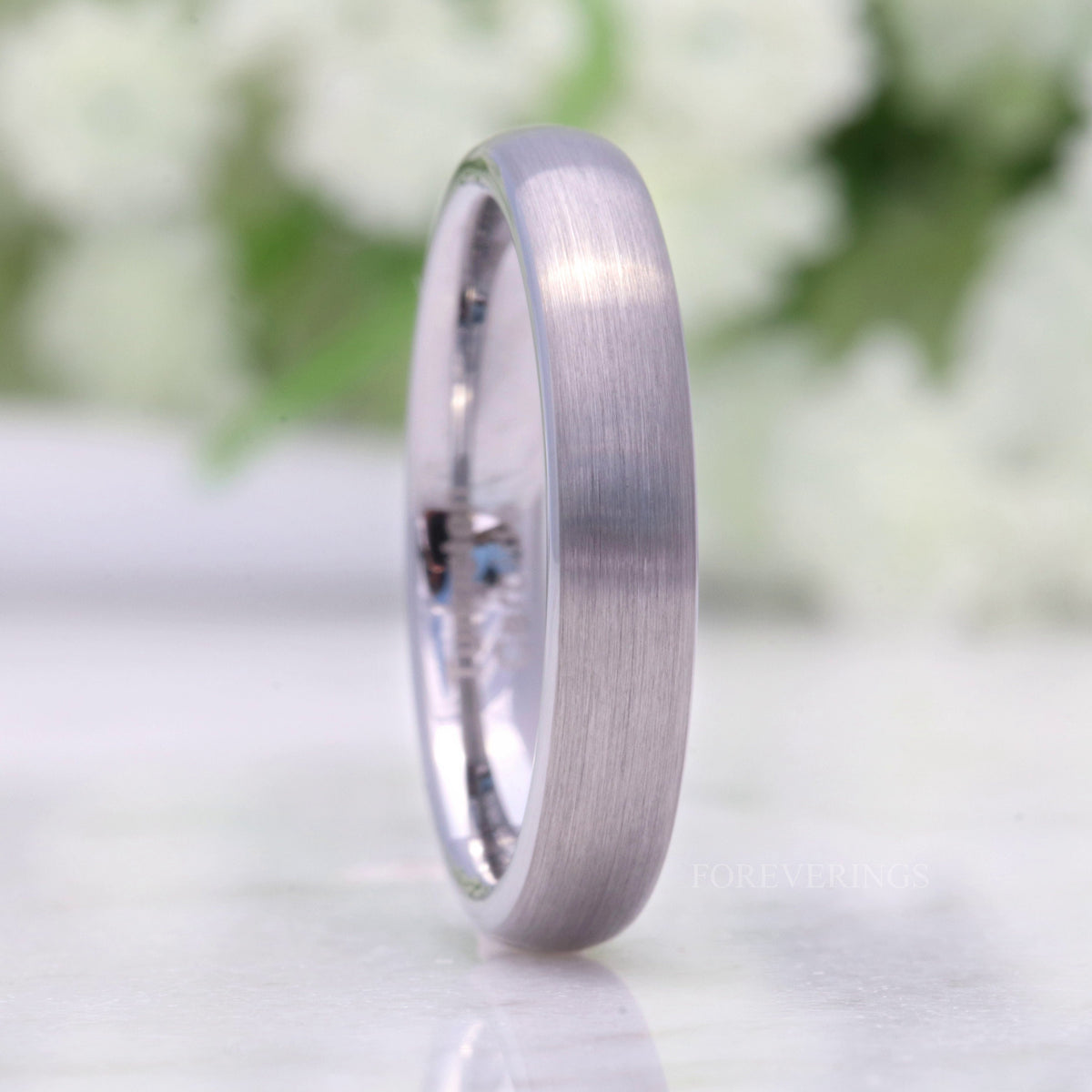4mm brushed silver tungsten wedding band standing upright, domed profile