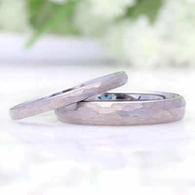 Hammered silver tungsten bands in 2mm and 4mm, the thinner one leaning on the wider