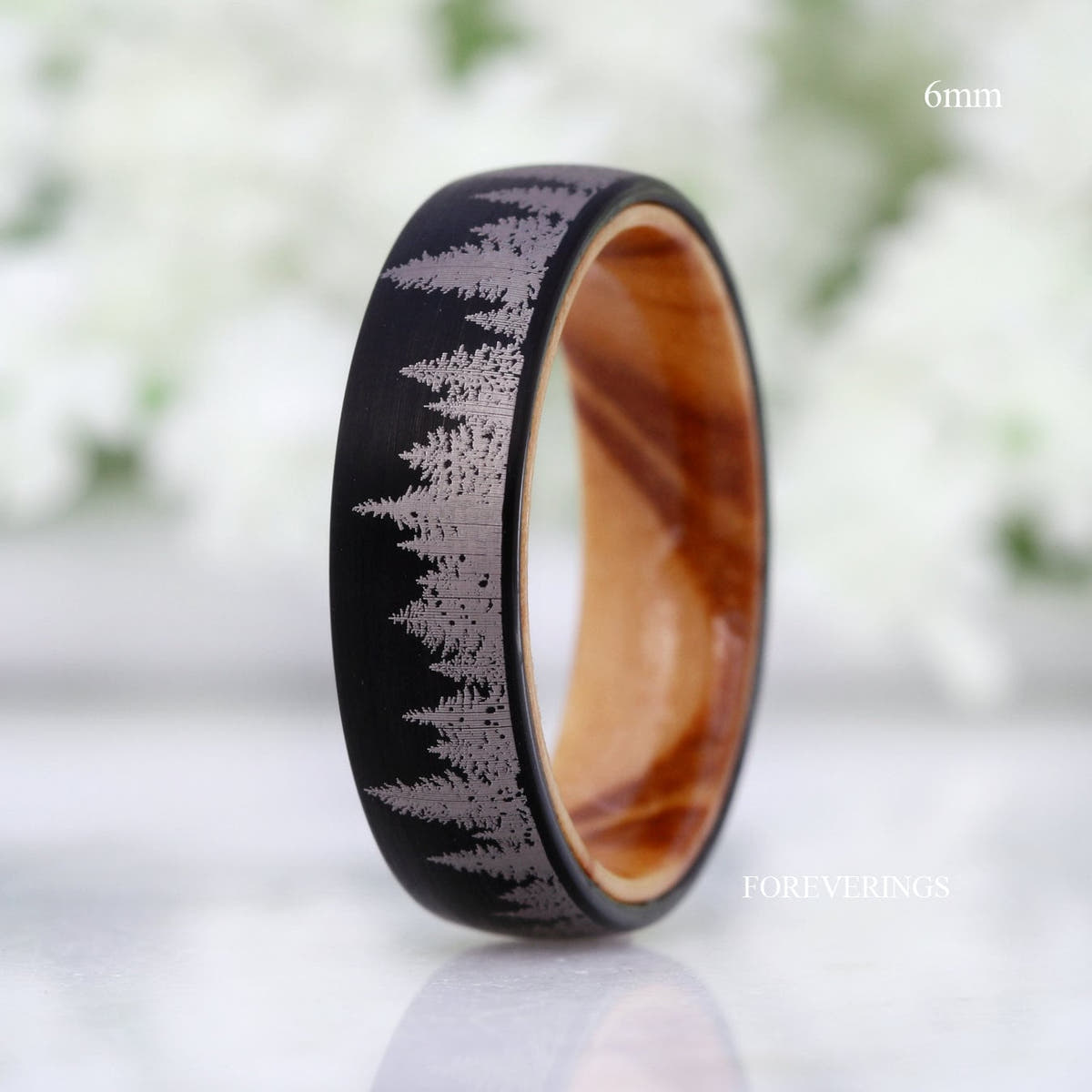 6mm black tungsten pine tree band with olive wood interior, standing upright