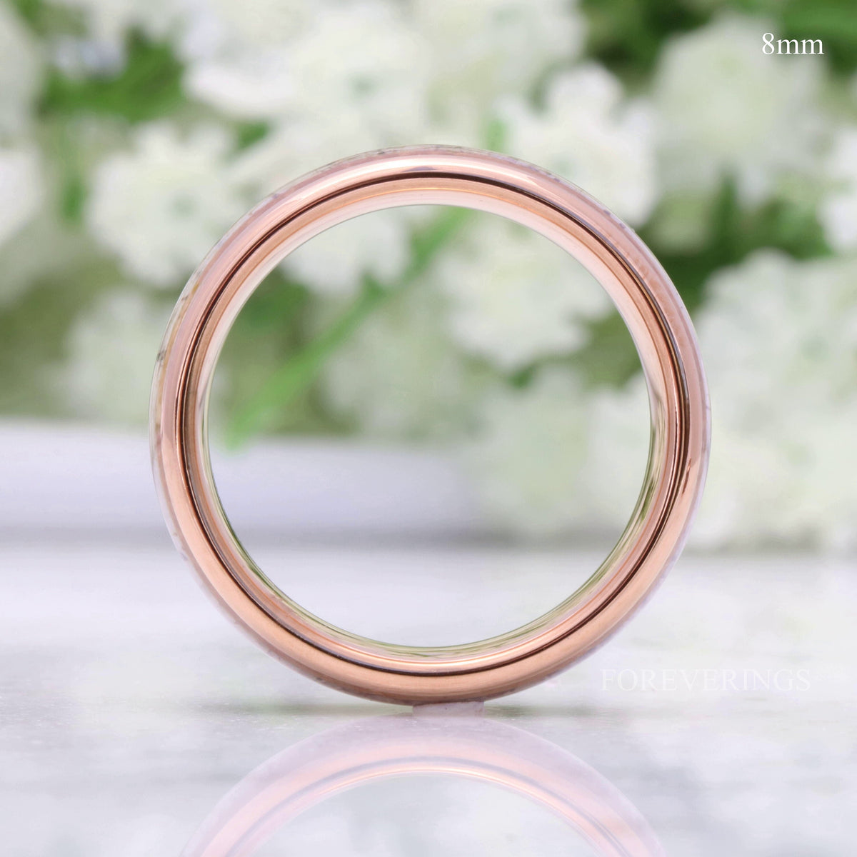 8mm rose gold tungsten whiskey barrel and antler band, viewed straight through the center