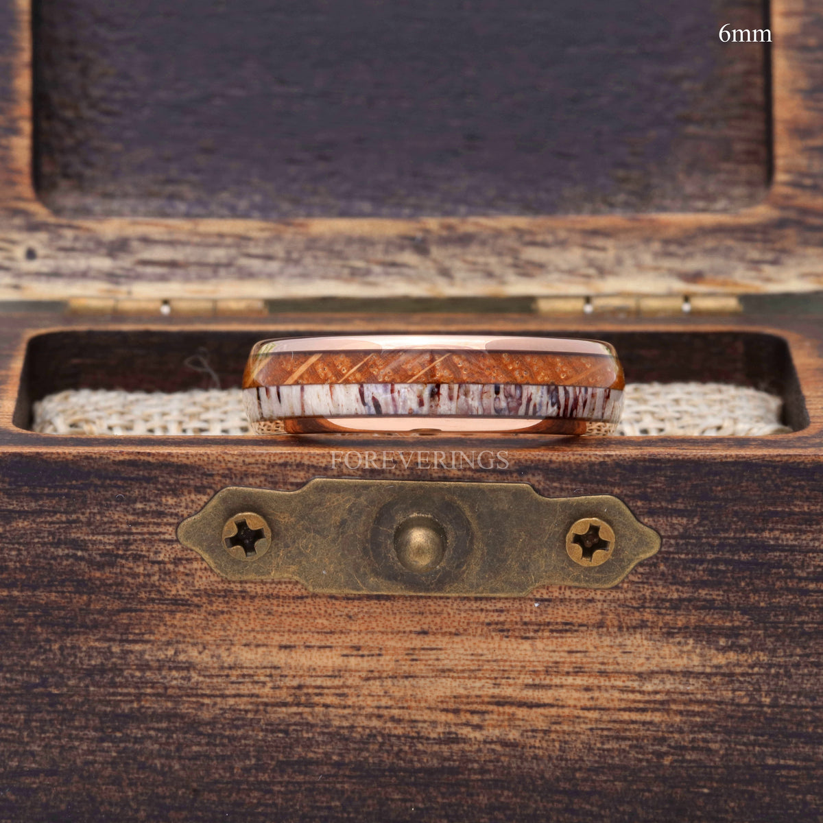 6mm rose gold tungsten whiskey barrel and antler band in a rustic wood ring box, seen from above