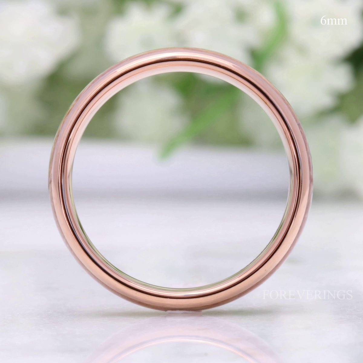 6mm rose gold tungsten whiskey barrel and antler band, viewed straight through the center