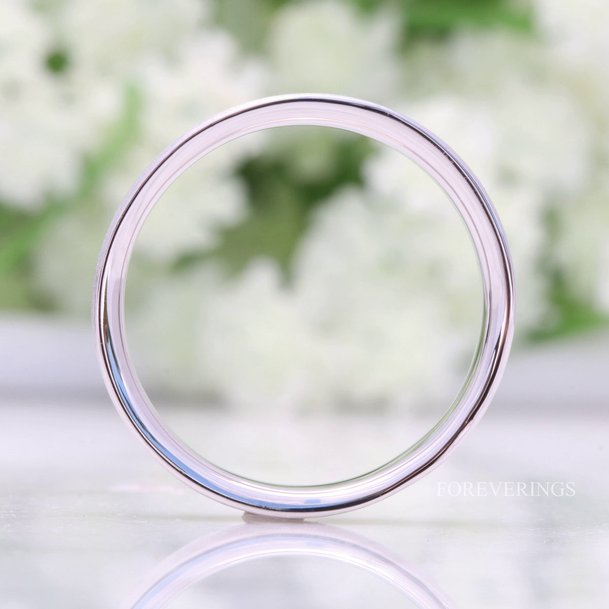Sterling silver wedding band viewed head-on through the center, thin flat profile
