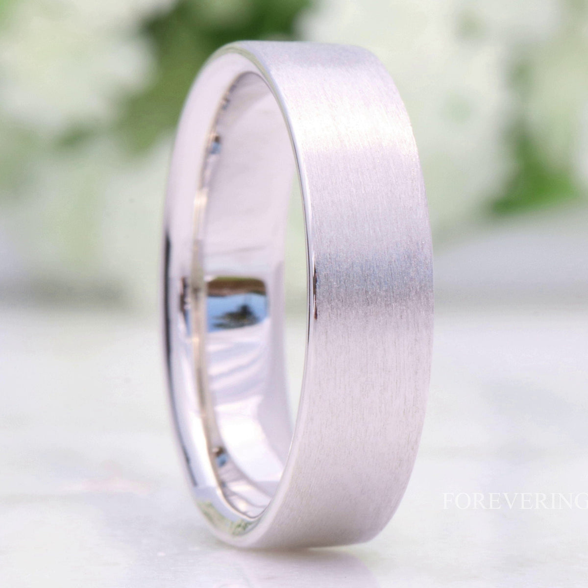 6mm brushed sterling silver wedding band, flat profile, standing close-up