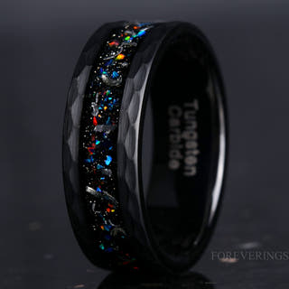 Hammered black tungsten band with meteorite and galaxy opal inlay, close-up angled view
