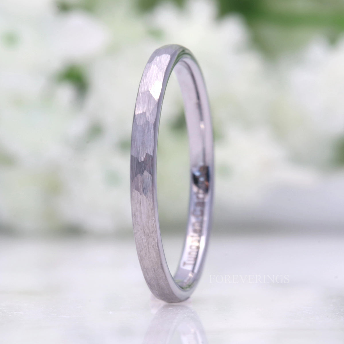 2mm hammered silver tungsten band standing on edge, matte faceted finish