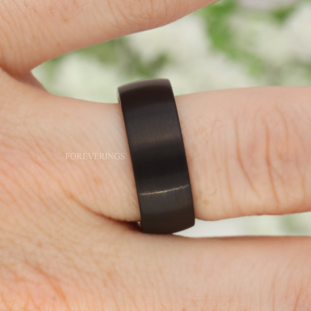 Black tungsten wenge wood band worn on a finger, brushed domed profile