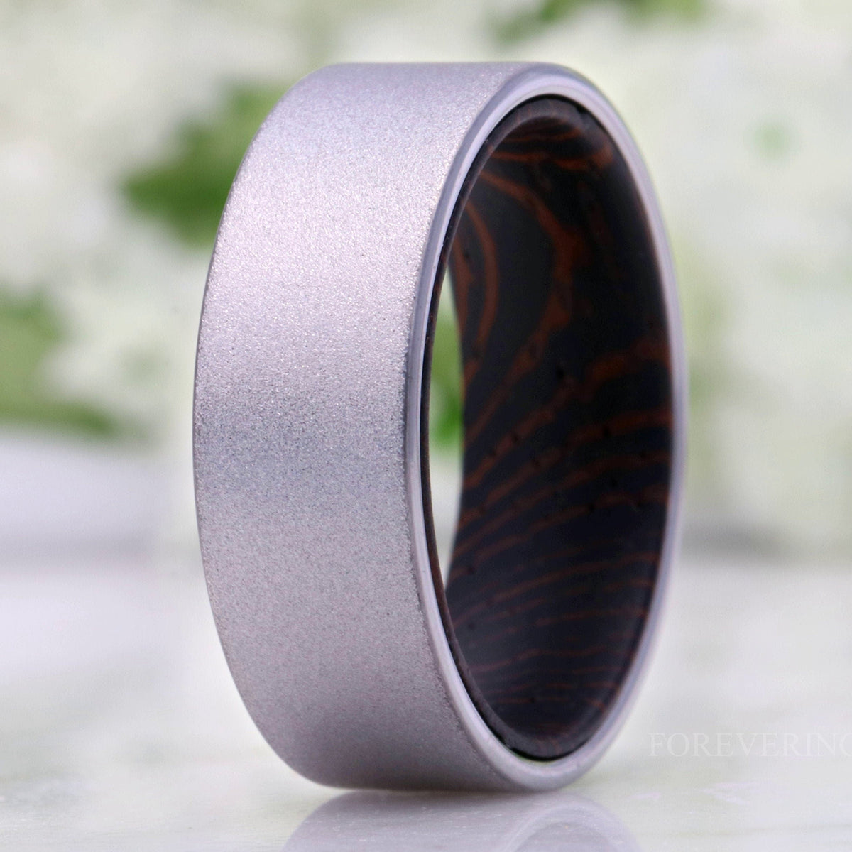 Men's 8mm sandblasted silver tungsten wedding band with a dark wenge wood sleeve