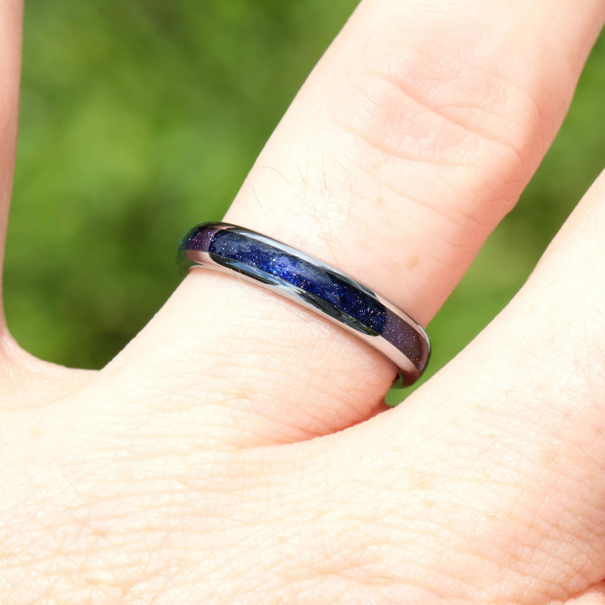 4mm silver tungsten blue sandstone ring worn on a finger, close view