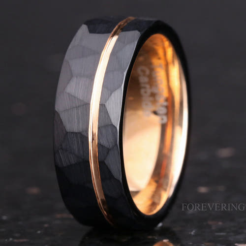 Men's 8mm hammered black tungsten band with a thin rose gold stripe, standing at an angle