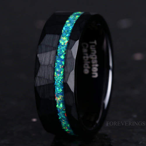 Men's 8mm hammered black tungsten ring with crushed green opal inlay, standing at an angle