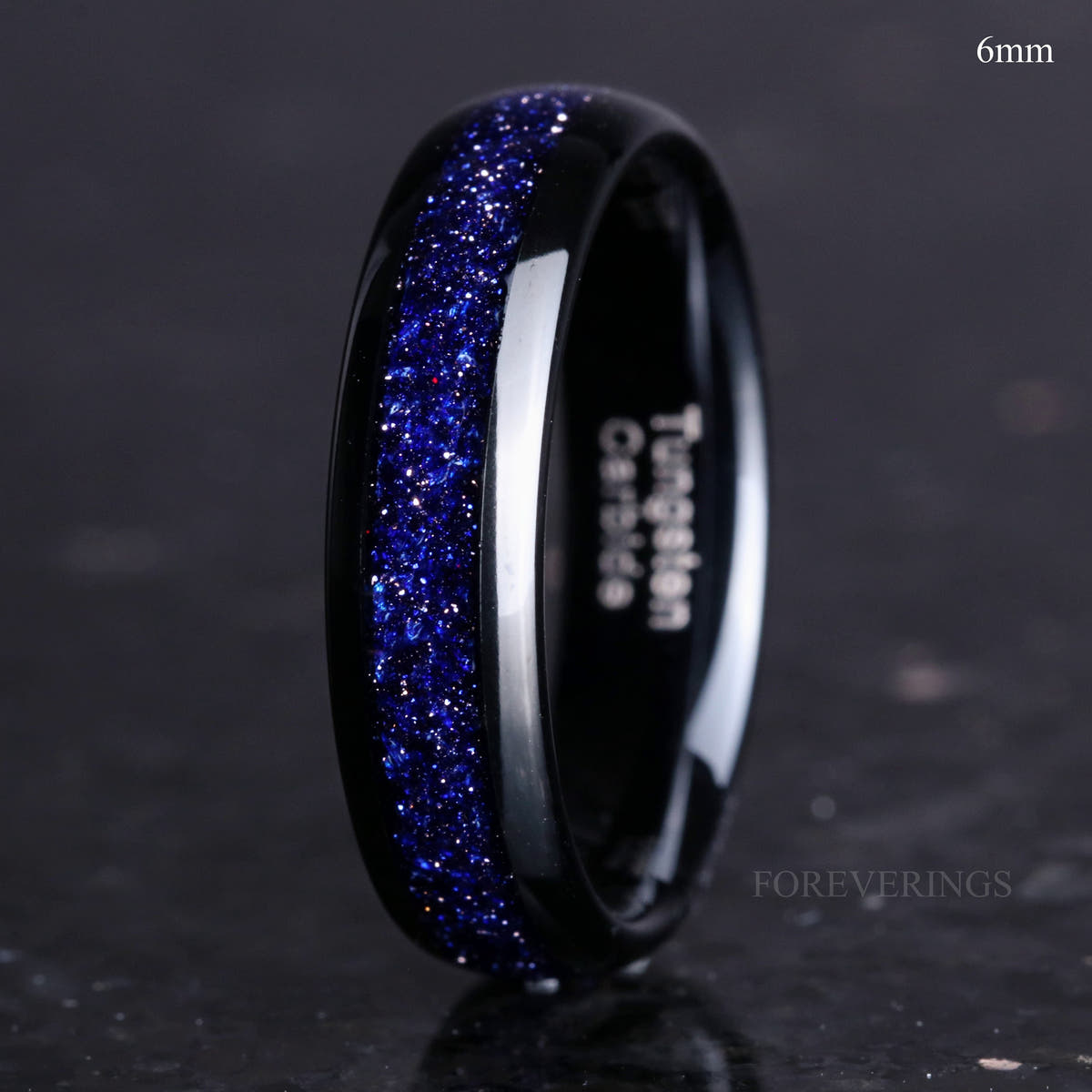 Black tungsten band labeled 6mm with Great Rift blue sandstone inlay, standing on edge