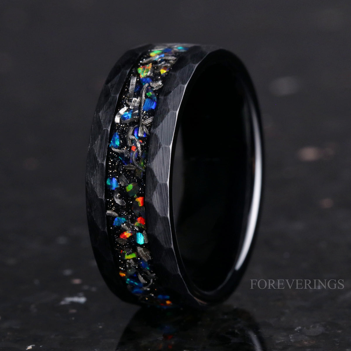Men's 8mm hammered black tungsten band with crushed meteorite and galaxy opal inlay, angled