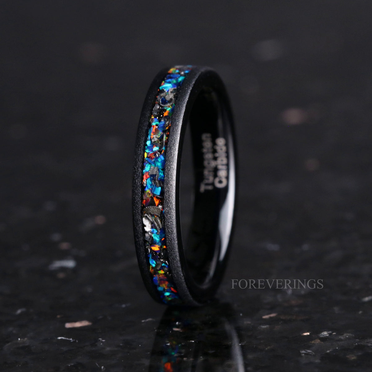 Women's 4mm black tungsten ring with meteorite and galaxy opal inlay, standing on edge
