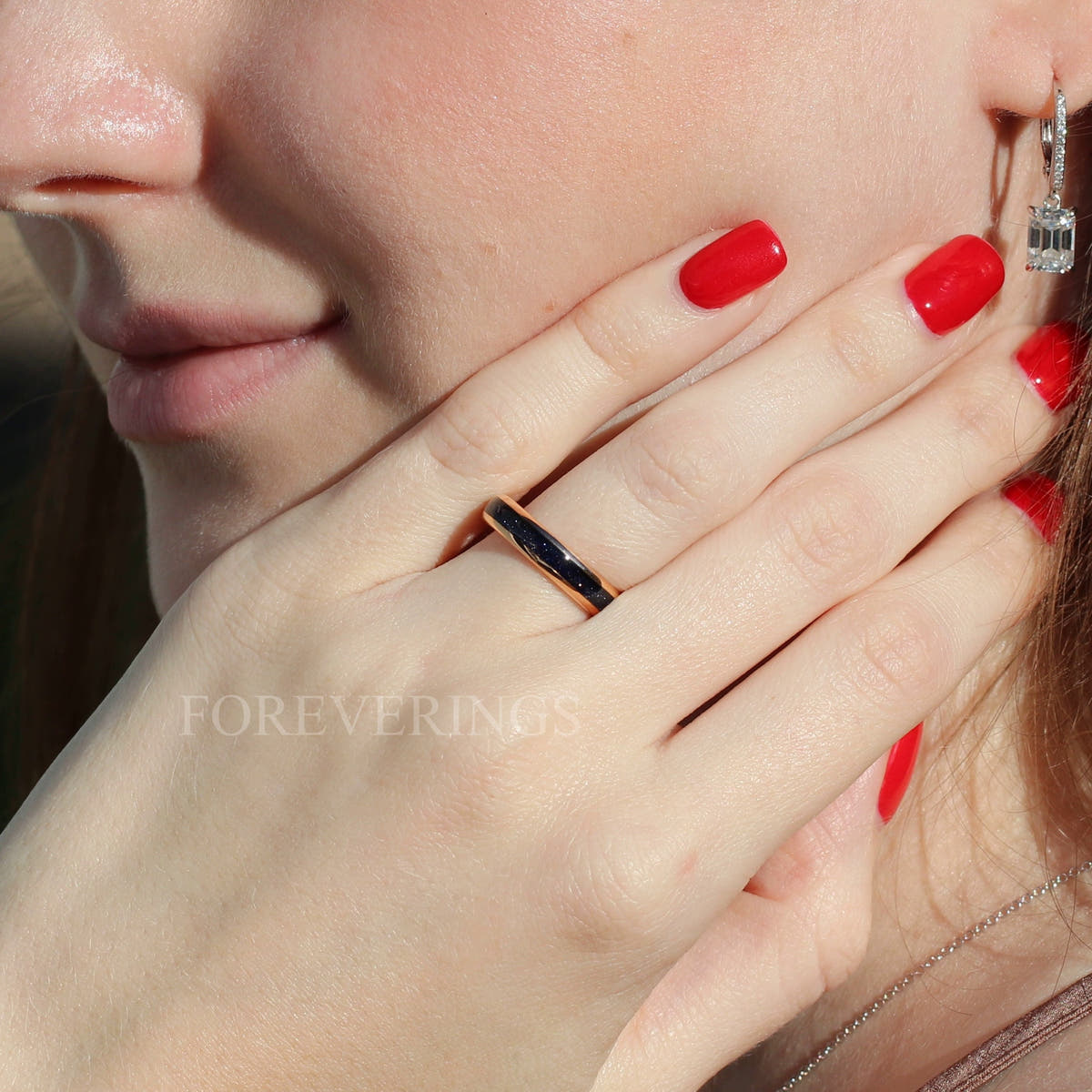4mm rose gold tungsten ring with blue sandstone inlay worn on a woman's hand
