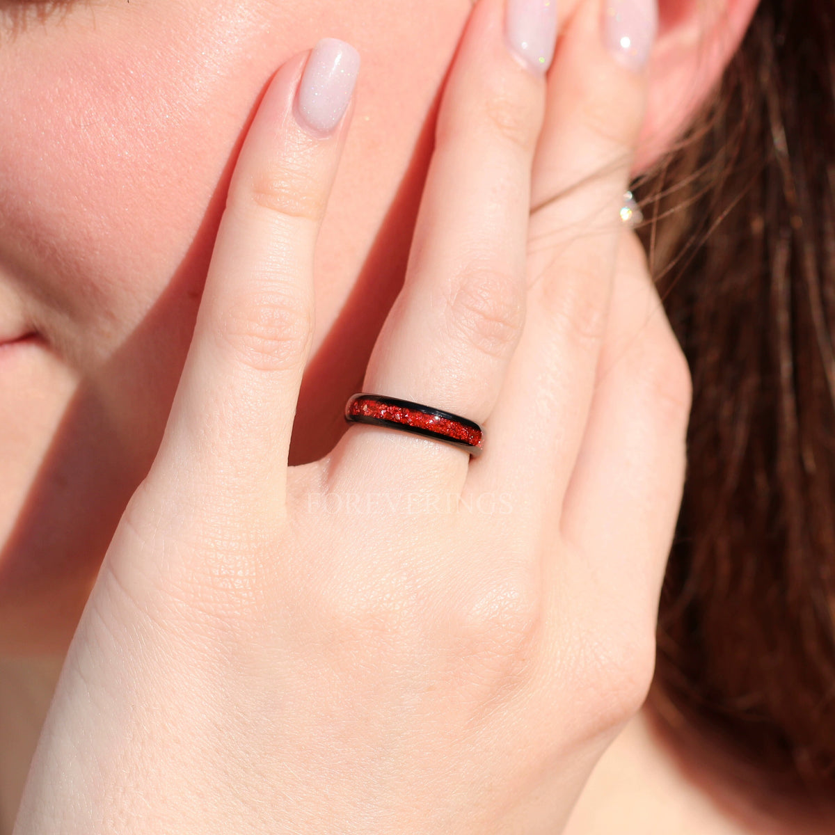 4mm black tungsten ruby inlay band worn on a hand