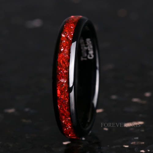 4mm black tungsten wedding band with a crushed ruby inlay, standing at an angle