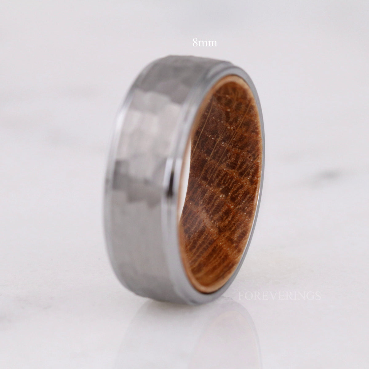 8mm hammered silver tungsten band with whiskey barrel wood interior, standing upright