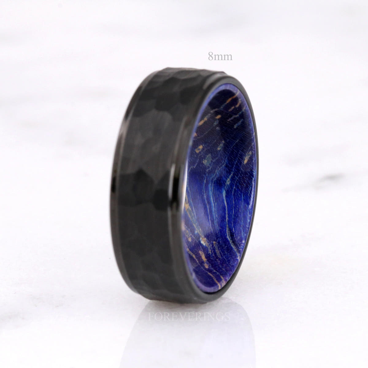 8mm black tungsten band standing upright, wavy blue elder wood grain inside, labeled 8mm