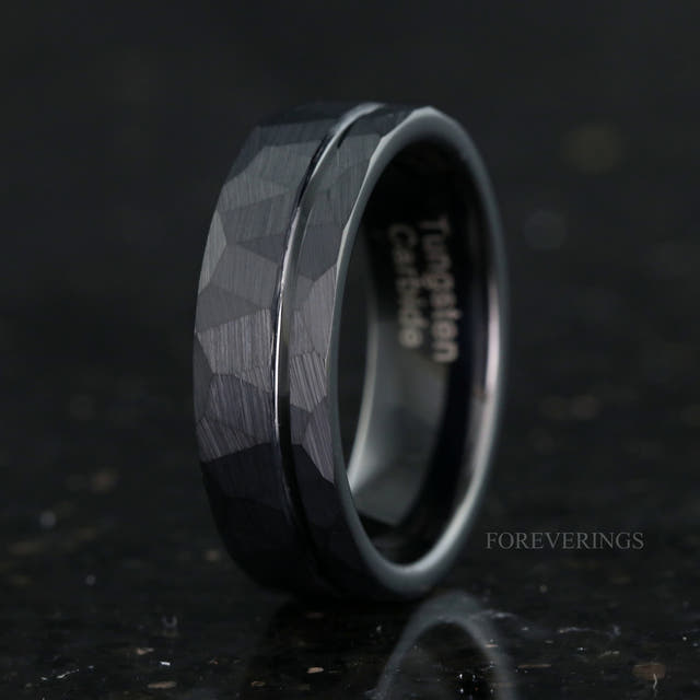 Men's 7mm hammered black tungsten band with an offset groove, standing at an angle