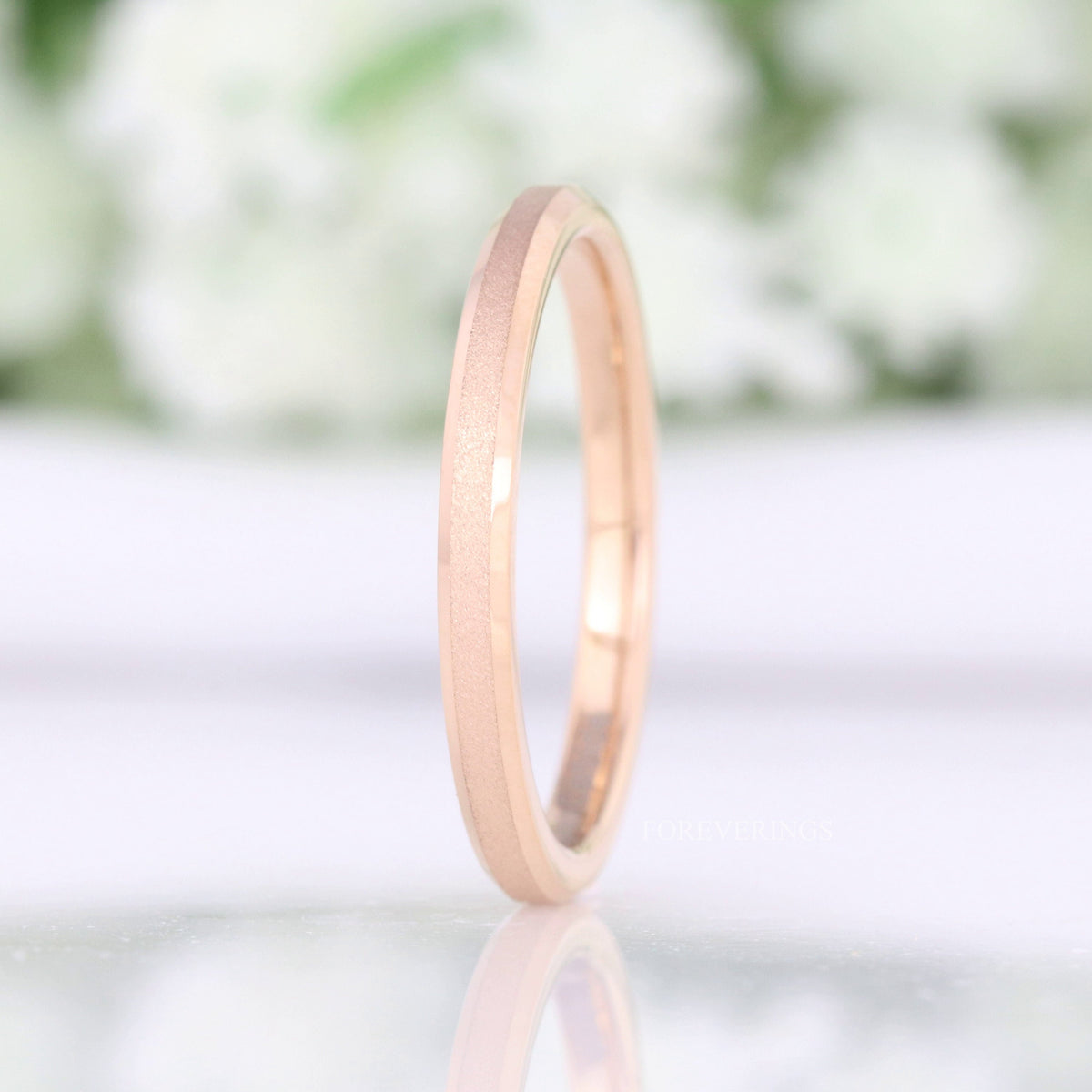 2mm sandblasted rose gold tungsten band standing upright, polished beveled edges