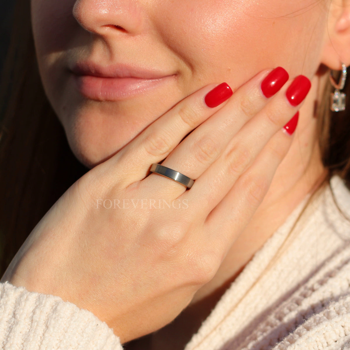 4mm flat silver tungsten ring worn on a woman's hand, wider view