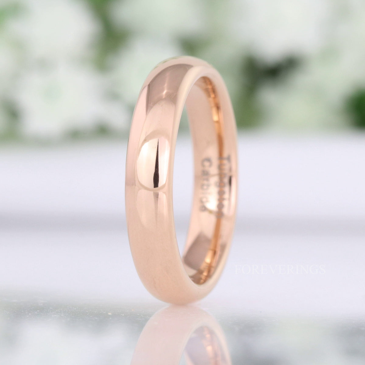 4mm rose gold tungsten band standing upright, polished dome