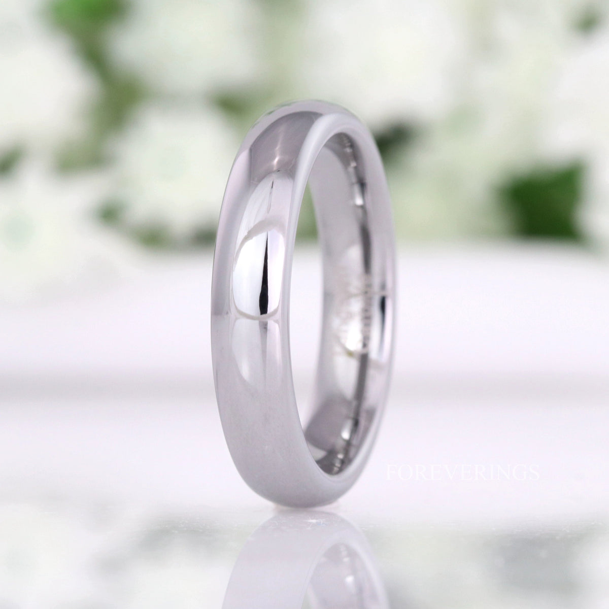 4mm polished silver tungsten wedding band standing upright, domed profile
